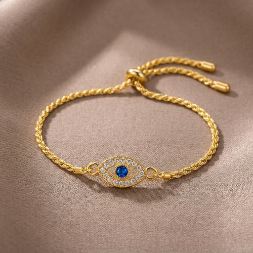 Macro studio detail of Aria Lucky Eye Bracelet — blue zircon eye, pavé clear stones, gold rope chain