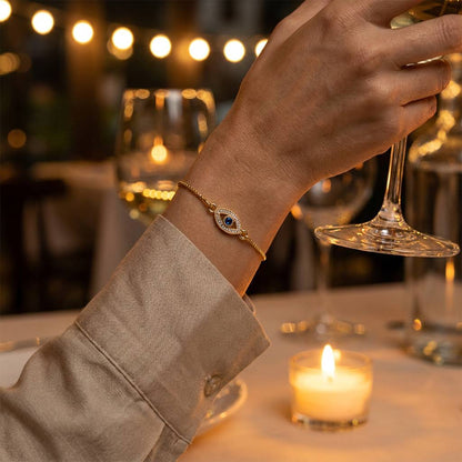 Aria Lucky Eye Bracelet at a candlelit dinner with silk-linen shirt